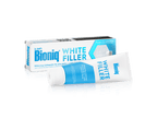 Zahnpasta „Bioniq White Filler“ mit liegender Tube vor der Verpackung; Text auf Packung: „Filler-Technologie mit 20% künstlichem Zahnschmelz“.